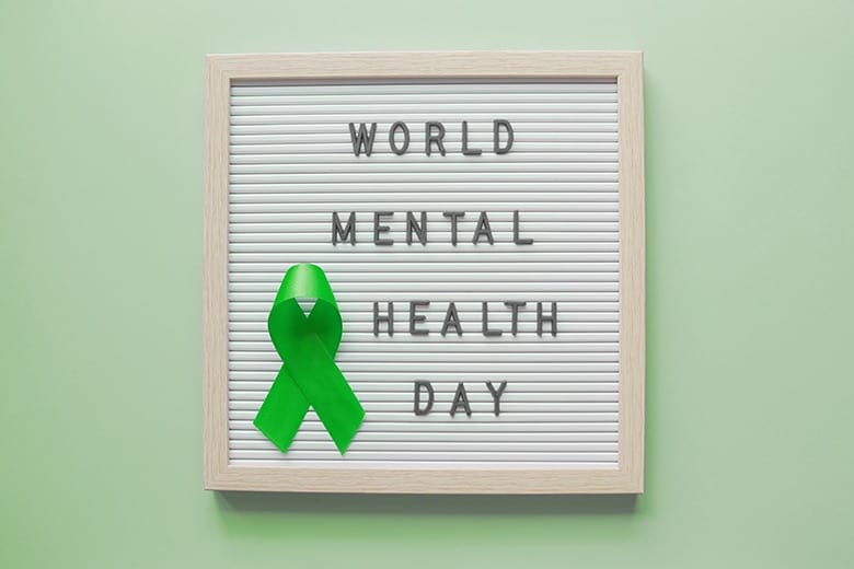 World mental health day and green ribbon on letter board