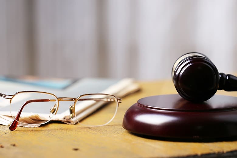 glasses-gavel-on-desk-social-security-disability-in-person-hearing