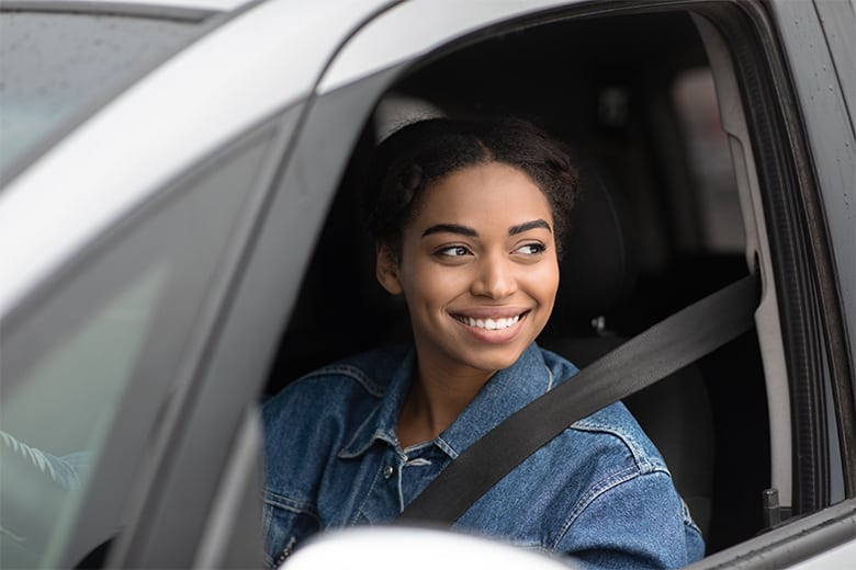 woman-in-car-driving-smiling